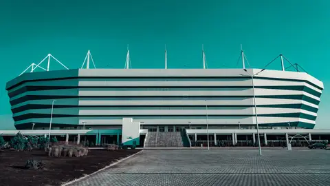 Front view of a modern stadium with unique architectural design captured outdoors.