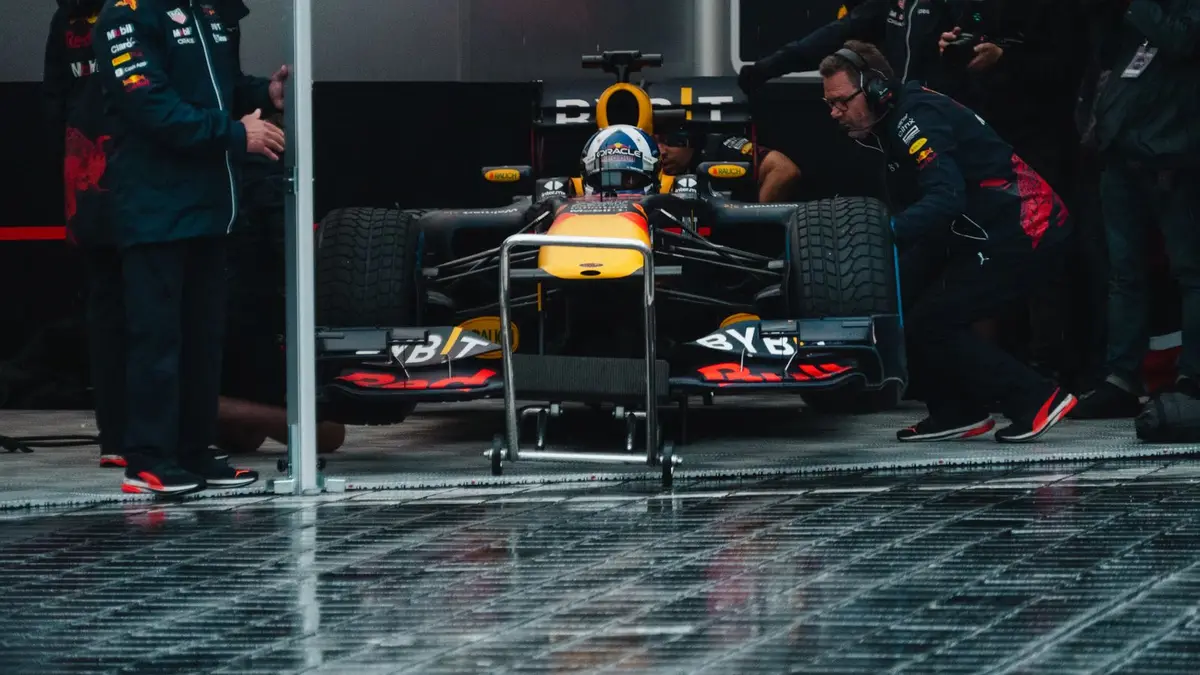 Red Bull Racing pit crew readying the Formula 1 car during an intense race event.
