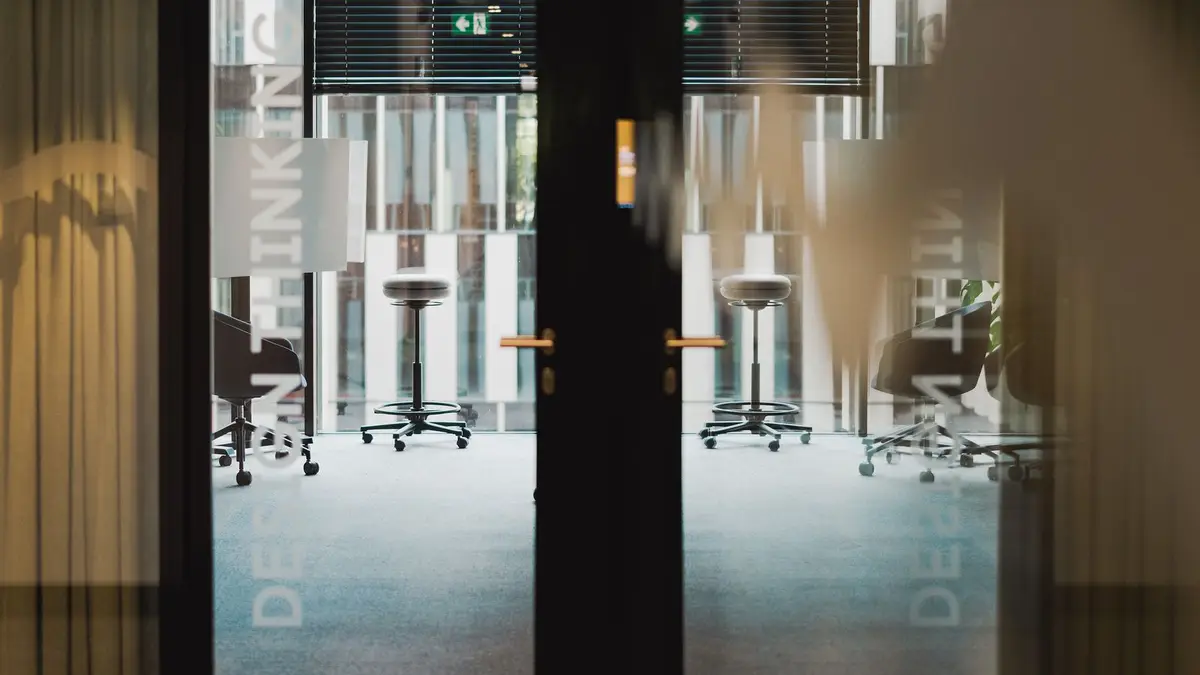 Contemporary office entrance showcasing an interior design studio with ergonomic furniture.
