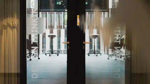 Contemporary office entrance showcasing an interior design studio with ergonomic furniture.
