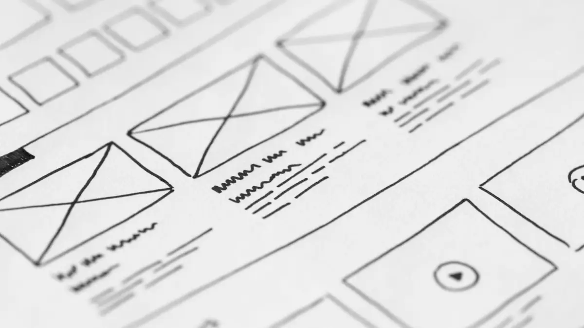 Detailed close-up of a hand-drawn wireframe design on paper for a UX project.