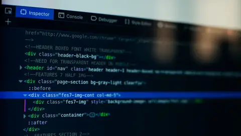 Detailed view of HTML code on a computer screen, ideal for tech and software development themes.