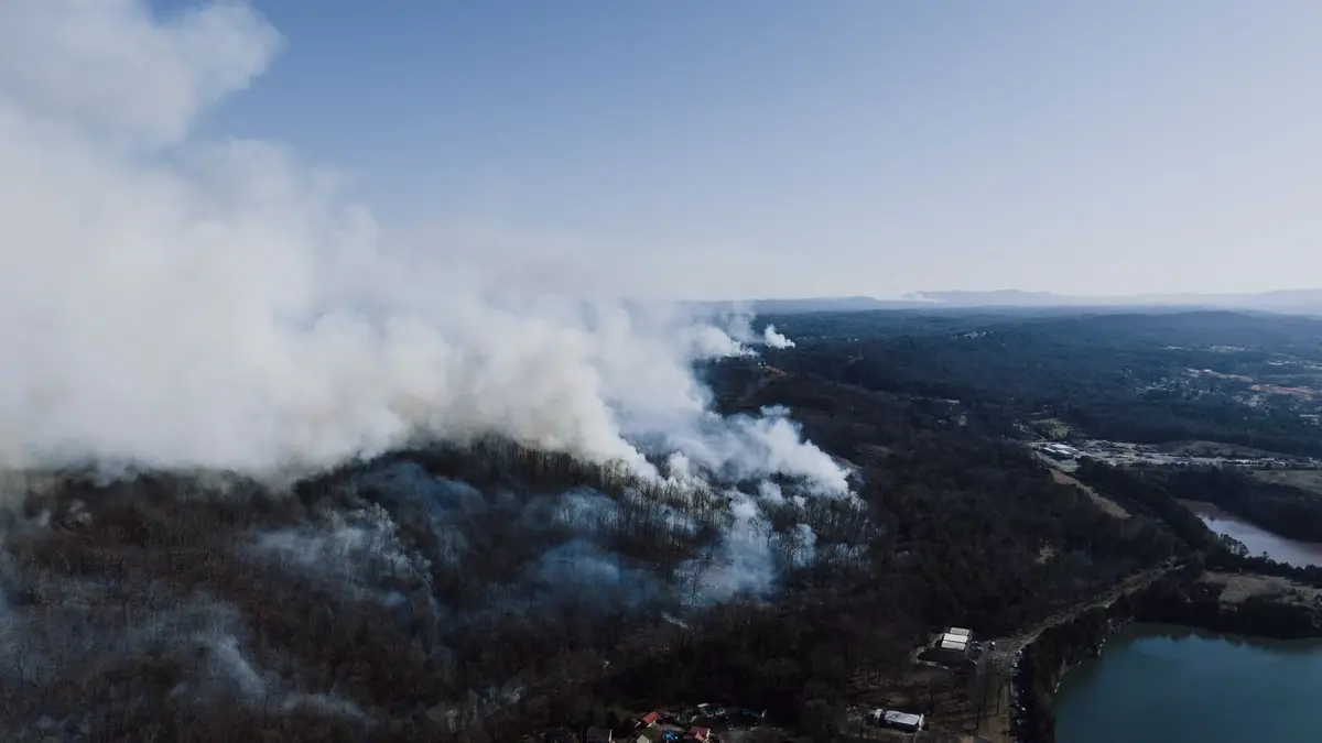 Drone view of a forest wildfire near Rossville, Georgia, USA, smoke rising.