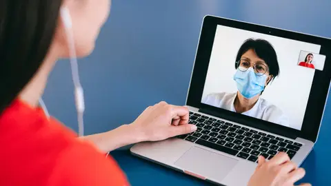 Doctor and patient on a video call for telehealth consultation during COVID-19 era.
