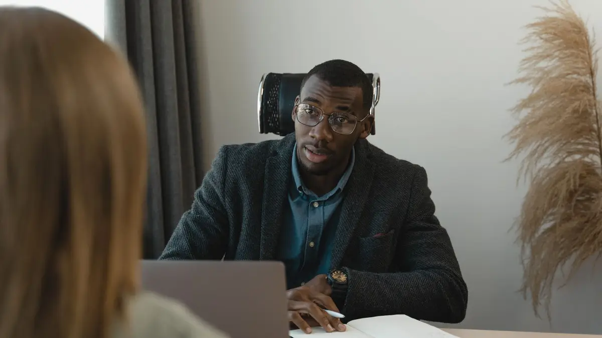 Businessman conducting a formal interview in a modern office environment.
