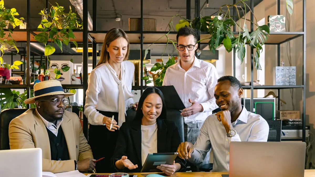 A group of diverse professionals working collaboratively in a modern office setting.
