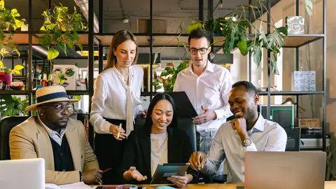 A group of diverse professionals working collaboratively in a modern office setting.