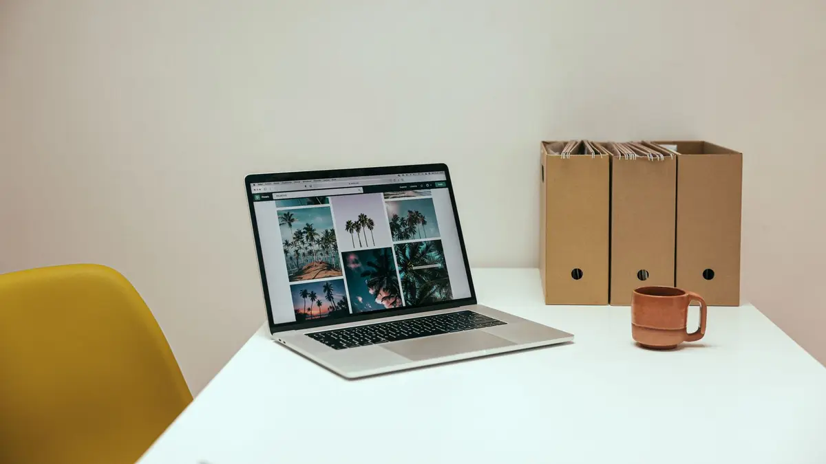 A cozy office desk setup with a laptop and coffee mug, perfect for productivity.