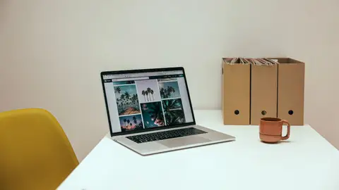 A cozy office desk setup with a laptop and coffee mug, perfect for productivity.
